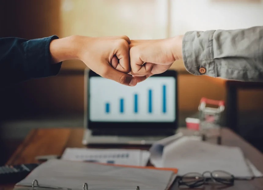 cropped-hands-people-giving-fist-bump-office